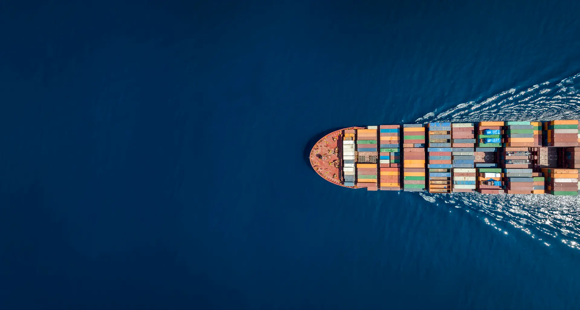 Aerial view of a container ship carrying goods across the ocean