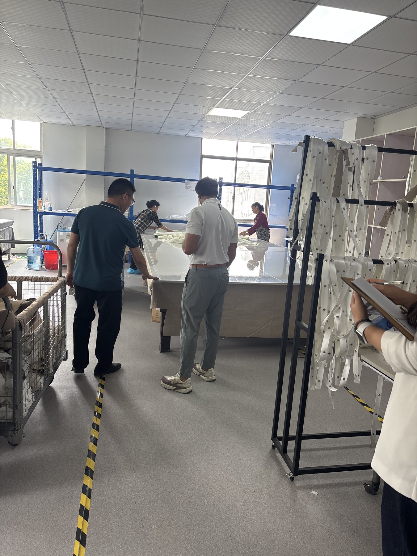 Buyer and supplier team reviewing materials inside a Chinese factory